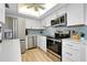 Bright kitchen with stainless steel appliances, white cabinets, and stylish backsplash at 6415 Midnight Pass Rd # 909, Sarasota, FL 34242
