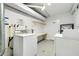 A shared laundry room with utility sink and storage shelves for the convenience of residents at 6415 Midnight Pass Rd # 909, Sarasota, FL 34242