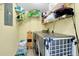 Laundry room with washer, dryer, storage and shelving at 6415 Midnight Pass Rd # 909, Sarasota, FL 34242