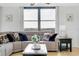 Bright living room featuring a comfortable sectional sofa, large windows and scenic views at 6415 Midnight Pass Rd # 909, Sarasota, FL 34242