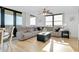 Open-concept living room with hardwood floors, a comfortable couch, and abundant natural light at 6415 Midnight Pass Rd # 909, Sarasota, FL 34242