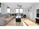 Bright living room with hardwood floors, a comfy couch, and expansive window views at 6415 Midnight Pass Rd # 909, Sarasota, FL 34242