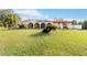 Expansive backyard of house featuring a pool, spacious green area, and lush tropical landscaping at 6427 Canary St, Sarasota, FL 34241