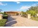 Inviting Mediterranean-style home featuring lush landscaping and a long brick driveway at 6427 Canary St, Sarasota, FL 34241