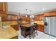 Kitchen featuring custom wood cabinets, granite countertops, a kitchen island, and stainless appliances at 6427 Canary St, Sarasota, FL 34241
