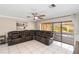 Spacious living room with tile floors, a leather sectional, and a view of the outdoor pool at 6427 Canary St, Sarasota, FL 34241