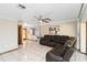 Bright living room with neutral walls, tile flooring, and a comfortable leather sectional at 6427 Canary St, Sarasota, FL 34241