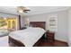 Spacious main bedroom featuring wood floors, and sliding glass doors to a backyard pool at 6427 Canary St, Sarasota, FL 34241