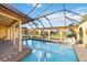 Gorgeous screened pool with seating area and view of the spacious backyard at 6427 Canary St, Sarasota, FL 34241