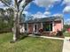 Inviting single-story home featuring a beautiful, verdant front lawn and established trees at 6478 Rosewood Dr, Englewood, FL 34224