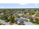 A serene neighborhood featuring well-kept homes, lush greenery, and a tranquil lake, creating a peaceful environment at 648 Cypress Rd, Venice, FL 34293