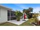 Well-maintained backyard with screened-in porch, patio and tropical landscaping at 648 Cypress Rd, Venice, FL 34293