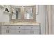 Bathroom with a double-sink vanity, granite countertop, and framed mirrors at 648 Cypress Rd, Venice, FL 34293