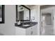 Bathroom featuring a granite countertop and a framed mirror at 648 Cypress Rd, Venice, FL 34293