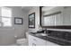 Bathroom with a granite countertop and framed mirror at 648 Cypress Rd, Venice, FL 34293