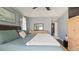 Comfortable bedroom with high ceilings, a dresser with a mirror, and walk-in closet access at 648 Cypress Rd, Venice, FL 34293