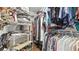 Organized walk-in closet with shelves, hanging rods, and wood flooring at 648 Cypress Rd, Venice, FL 34293