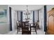 A dining room with a table, chairs, and a chandelier at 648 Cypress Rd, Venice, FL 34293