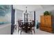 Dining room with wood table, neutral tones, and natural light; perfect for Gathering meals and dinner parties at 648 Cypress Rd, Venice, FL 34293