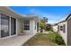 Exterior view of home featuring tropical landscaping, shed, and screened-in porch at 648 Cypress Rd, Venice, FL 34293