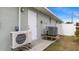 Exterior view of home featuring updated AC equipment and outdoor access at 648 Cypress Rd, Venice, FL 34293