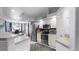 A view of the kitchen featuring stainless steel appliances and white cabinets at 648 Cypress Rd, Venice, FL 34293