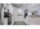 A spacious kitchen with white cabinets, stainless steel appliances, and tile floors at 648 Cypress Rd, Venice, FL 34293