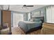 Main bedroom featuring blue walls, a ceiling fan, and a view to the outside at 648 Cypress Rd, Venice, FL 34293