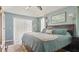 Main bedroom with a light blue wall color, ceiling fan, and sliding glass door at 648 Cypress Rd, Venice, FL 34293
