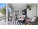 Relaxing screened-in porch with wicker furniture, ceiling fan, and tiled flooring at 648 Cypress Rd, Venice, FL 34293