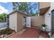 Outdoor patio area with a shed containing a washer and dryer unit at 726 Bird Bay Cir # 46, Venice, FL 34285