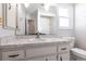 Bathroom features a large mirror, vanity, and toilet with neutral color palette at 781 Missouri Rd, Venice, FL 34293