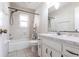 This bathroom features a vanity, sink, and a shower-tub combo with floral curtains at 781 Missouri Rd, Venice, FL 34293