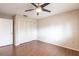 This bedroom features hardwood floors, ceiling fan, and a closet with folding doors at 781 Missouri Rd, Venice, FL 34293