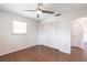 This bedroom features wood floors, ceiling fan, and a closet with folding doors at 781 Missouri Rd, Venice, FL 34293