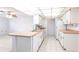 Well-lit kitchen boasting white cabinetry and an island sink, ideal for meal preparation and socializing at 781 Missouri Rd, Venice, FL 34293