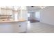 Open-concept kitchen with tile floors, neutral colors, and modern countertops, seamlessly connecting to the living space at 781 Missouri Rd, Venice, FL 34293