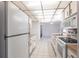 Functional kitchen features white appliances, tile floors, and wood countertops providing a classic and practical design at 781 Missouri Rd, Venice, FL 34293