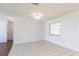 Bright living space features neutral walls and tile flooring, creating a clean and airy atmosphere at 781 Missouri Rd, Venice, FL 34293