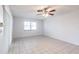 Bright living room with tile flooring and a ceiling fan, ready for your personal touch and decor at 781 Missouri Rd, Venice, FL 34293