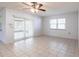 Open living area with tile flooring, ceiling fan, and sliding glass door for natural light and easy outdoor access at 781 Missouri Rd, Venice, FL 34293
