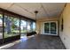 This outdoor patio features a screened enclosure and a sliding glass door at 781 Missouri Rd, Venice, FL 34293
