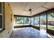 This outdoor patio features a screened enclosure with a peek at the backyard at 781 Missouri Rd, Venice, FL 34293