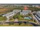 Aerial view of a community with a pool, ponds, walking trails, and convenient carport parking at 872 Saranac Lake Dr # 103, Venice, FL 34292