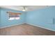 Comfortable bedroom with light blue walls, ceiling fan, and wood-look floors at 891 Grado Dr, Venice, FL 34285