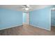 Light-filled bedroom featuring wood-look flooring, light blue walls, and a ceiling fan at 891 Grado Dr, Venice, FL 34285