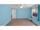 Bedroom featuring wood-look floors, light blue walls, and a bright window at 891 Grado Dr, Venice, FL 34285