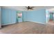 Inviting bedroom featuring blue walls, light wood floors, and a modern ceiling fan at 891 Grado Dr, Venice, FL 34285