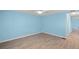 This bedroom features wood-look flooring, light blue walls, and a ceiling fan at 891 Grado Dr, Venice, FL 34285