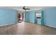 Inviting bedroom featuring blue walls, light wood floors, ceiling fan, and sliding glass door at 891 Grado Dr, Venice, FL 34285